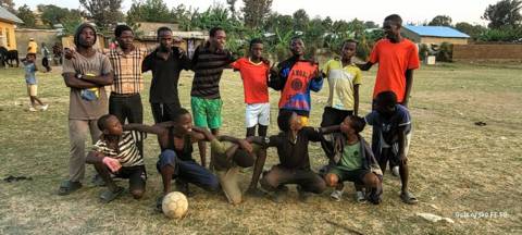 The same group of players posing on the pitch, a second shot